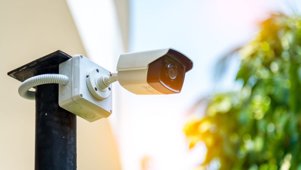 Technician installing IP wireless CCTV camera by screwed for hom