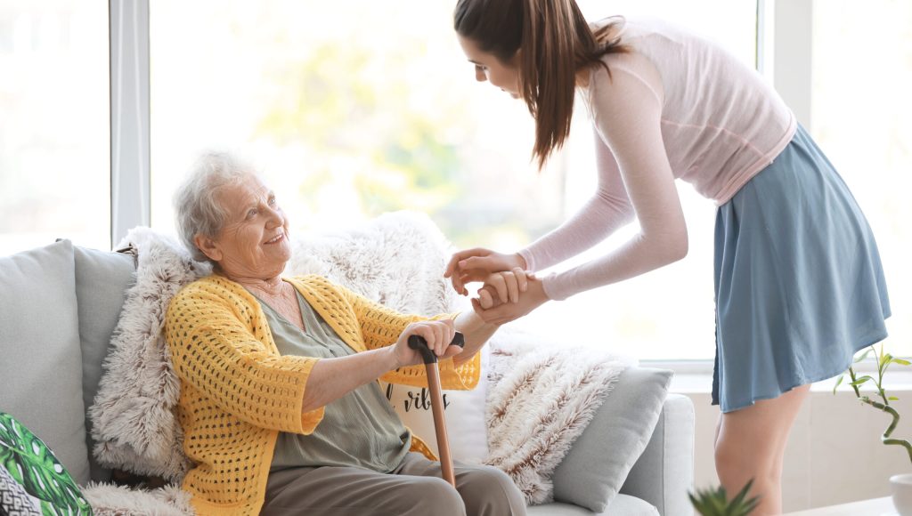 Caregiver with senior woman in nursing home