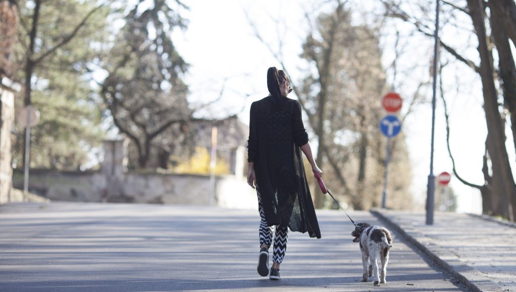 woman and her dog taking a walk