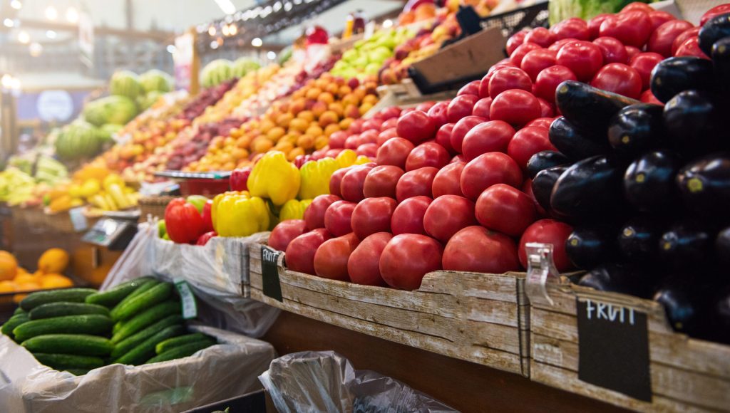 Vegetable farmer market counter: colorful various fresh organic healthy vegetables at grocery store. Healthy natural food concept