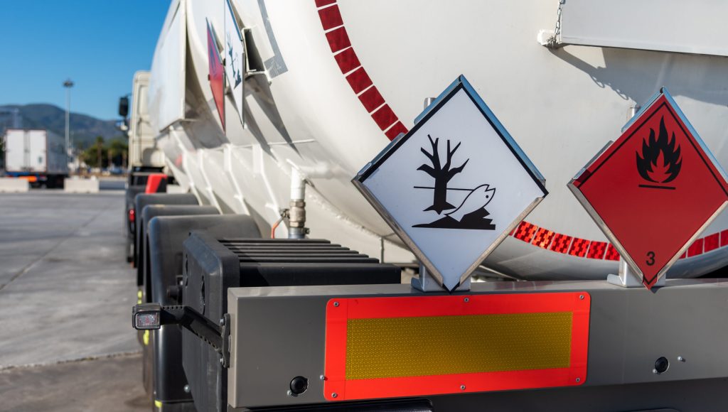 Tank truck with dangerous goods, with labels of flammable and po